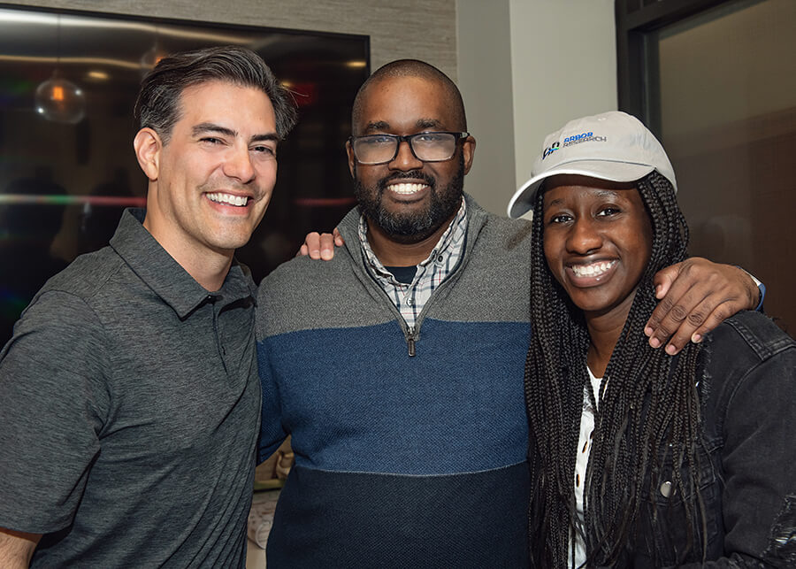 Three Arbor Research employees pose for a photo